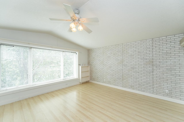 510 24th St SW, Rochester, MN 55902 - spare room with wood finished floors, brick wall, lofted ceiling, and ceiling fan