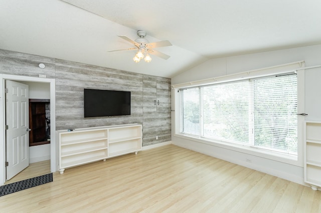 510 24th St SW, Rochester, MN 55902 - unfurnished living room featuring an accent wall, wood finished floors, a ceiling fan, and vaulted ceiling