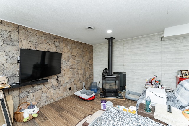 510 24th St SW, Rochester, MN 55902 - living area with wood finished floors, a wood stove, and a textured ceiling