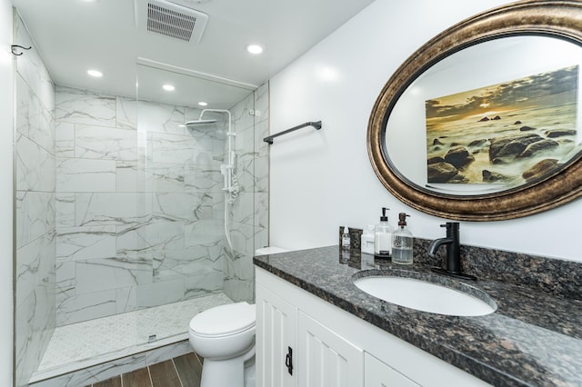 510 24th St SW, Rochester, MN 55902 - bathroom featuring vanity, recessed lighting, a marble finish shower, and wood finished floors