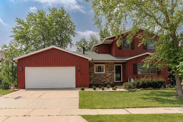 510 24th St SW, Rochester, MN 55902 - view of front of house featuring an attached garage, a front yard, driveway, roof with shingles, and board and batten siding