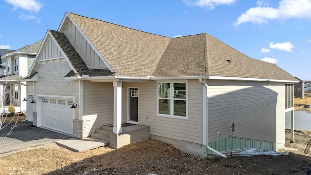 10180 Shadyview Ln N, Maple Grove, MN 55311 - view of front facade featuring a shingled roof, a garage, driveway, and board and batten siding