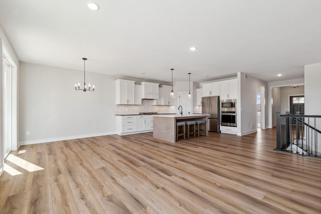 10180 Shadyview Ln N, Maple Grove, MN 55311 - kitchen with stainless steel appliances, open floor plan, backsplash, a kitchen bar, and light wood-style floors