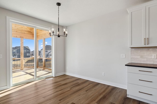 10180 Shadyview Ln N, Maple Grove, MN 55311 - unfurnished dining area featuring a chandelier and dark wood-style floors