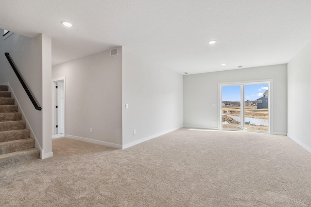10180 Shadyview Ln N, Maple Grove, MN 55311 - unfurnished living room with carpet, stairway, and recessed lighting