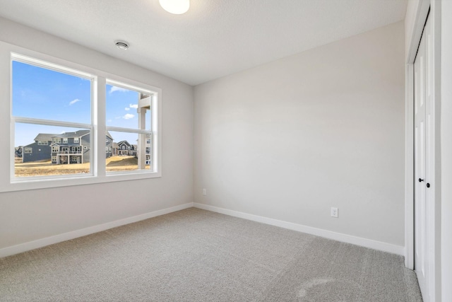 10180 Shadyview Ln N, Maple Grove, MN 55311 - carpeted spare room featuring baseboards and a smoke detector