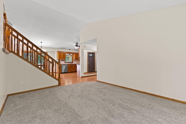 17865 Fillmore St NE, Ham Lake, MN 55304 - unfurnished living room featuring light colored carpet, stairway, a ceiling fan, and lofted ceiling