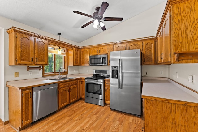 17865 Fillmore St NE, Ham Lake, MN 55304 - kitchen with appliances with stainless steel finishes, brown cabinets, vaulted ceiling, and light countertops