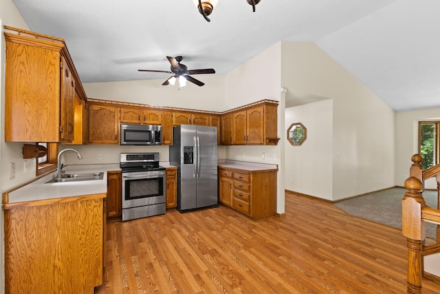 17865 Fillmore St NE, Ham Lake, MN 55304 - kitchen featuring appliances with stainless steel finishes, light wood-type flooring, brown cabinetry, ceiling fan, and high vaulted ceiling