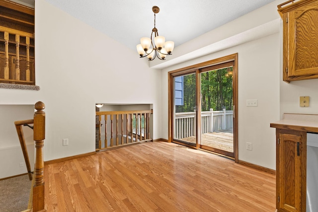 17865 Fillmore St NE, Ham Lake, MN 55304 - unfurnished dining area featuring light wood-style flooring and a chandelier