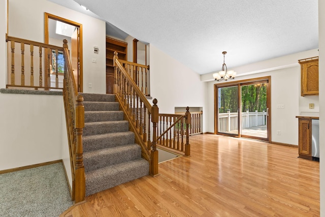 17865 Fillmore St NE, Ham Lake, MN 55304 - staircase with wood finished floors and a chandelier