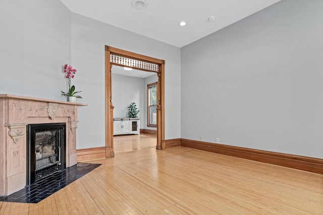 1813 11th Ave S, Minneapolis, MN 55404 - unfurnished living room featuring wood-type flooring, a premium fireplace, and recessed lighting