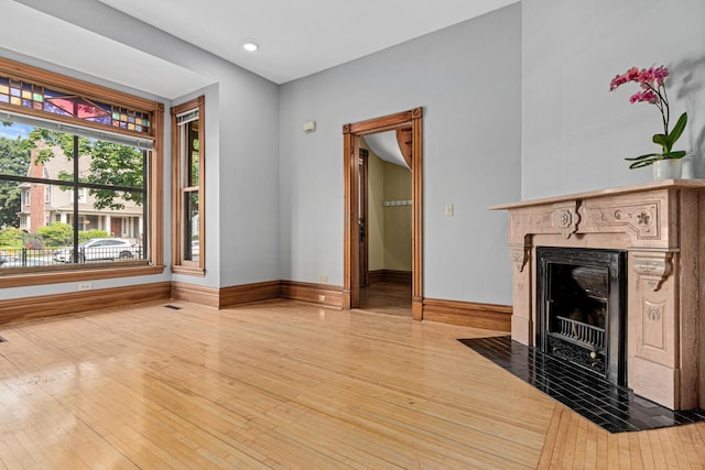 1813 11th Ave S, Minneapolis, MN 55404 - unfurnished living room featuring light wood-type flooring, a high end fireplace, and recessed lighting