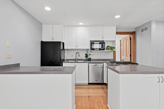 1813 11th Ave S, Minneapolis, MN 55404 - kitchen featuring black appliances, a peninsula, white cabinets, and recessed lighting
