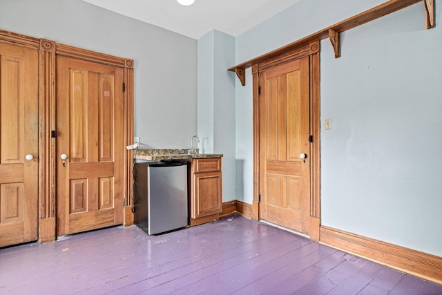 1813 11th Ave S, Minneapolis, MN 55404 - indoor wet bar with freestanding refrigerator and dark wood finished floors