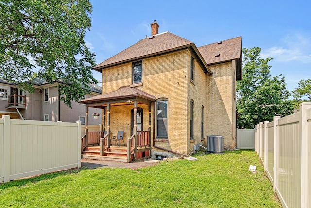 1813 11th Ave S, Minneapolis, MN 55404 - back of property featuring brick siding, a shingled roof, a chimney, and a fenced backyard