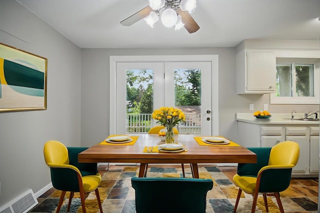 455 Sylvan St, Owatonna, MN 55060 - dining space with healthy amount of natural light, stone finish floors, and a ceiling fan