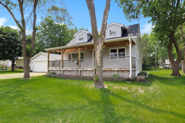 1115 3rd St NW, Faribault, MN 55021 - view of front facade featuring covered porch, a front yard, an outdoor structure, a garage, and concrete driveway
