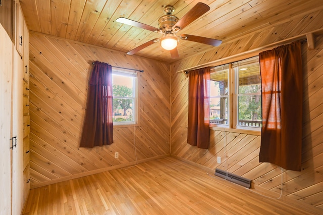 1115 3rd St NW, Faribault, MN 55021 - empty room with wood walls, a ceiling fan, wood finished floors, and wood ceiling