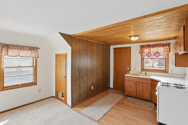 1115 3rd St NW, Faribault, MN 55021 - kitchen with white range with gas stovetop, light countertops, and brown cabinets
