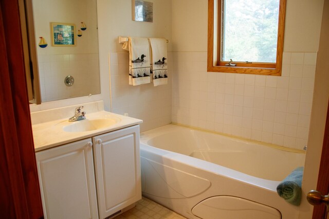 29042 County Road 4, Breezy Point, MN 56472 - bathroom with vanity, a garden tub, tile walls, and tile patterned floors