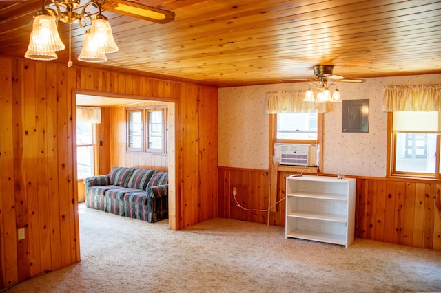 29042 County Road 4, Breezy Point, MN 56472 - unfurnished living room with a ceiling fan, electric panel, wooden walls, cooling unit, and a wainscoted wall