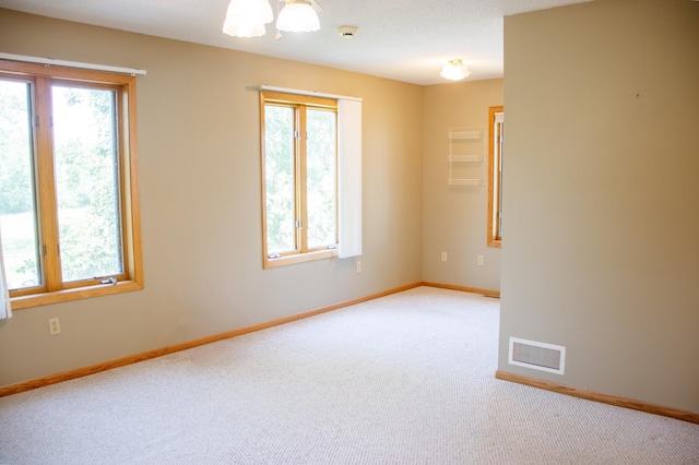 29042 County Road 4, Breezy Point, MN 56472 - spare room featuring plenty of natural light, light carpet, and a smoke detector