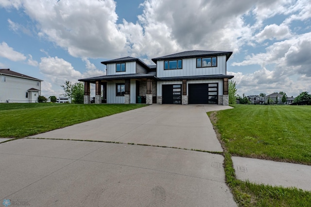 3405 4th St E, West Fargo, ND 58078 - view of front of house featuring stone siding, a front lawn, an attached garage, and concrete driveway