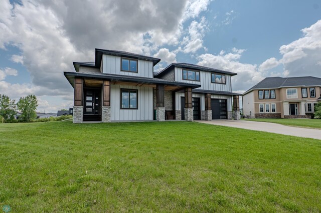 3405 4th St E, West Fargo, ND 58078 - view of front of house with board and batten siding, stone siding, concrete driveway, a garage, and a front yard