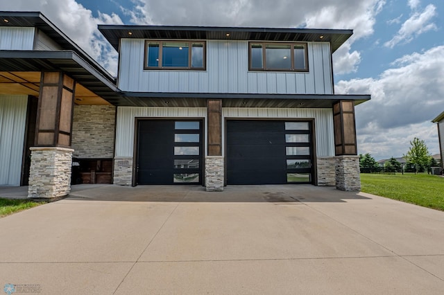 3405 4th St E, West Fargo, ND 58078 - view of front of property with stone siding, driveway, and an attached garage