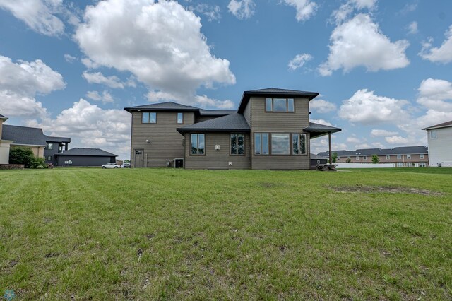 3405 4th St E, West Fargo, ND 58078 - rear view of house featuring a yard
