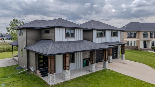 3405 4th St E, West Fargo, ND 58078 - view of front of house featuring board and batten siding, concrete driveway, an attached garage, a front lawn, and roof with shingles