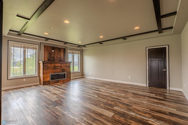 3405 4th St E, West Fargo, ND 58078 - unfurnished living room featuring dark wood-type flooring, a tile fireplace, recessed lighting, and beam ceiling