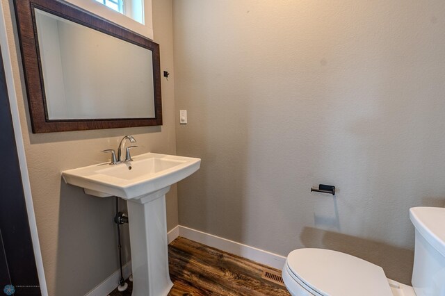 3405 4th St E, West Fargo, ND 58078 - half bathroom with toilet and wood finished floors