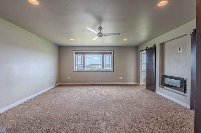 3405 4th St E, West Fargo, ND 58078 - spare room with a barn door, ceiling fan, carpet, and recessed lighting