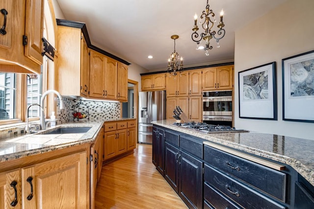 13907 Washington St NE, Ham Lake, MN 55304 - kitchen with appliances with stainless steel finishes, a chandelier, decorative backsplash, light wood finished floors, and light stone countertops