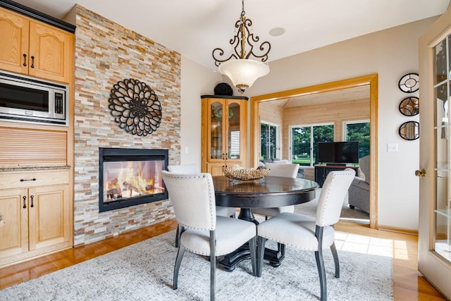 13907 Washington St NE, Ham Lake, MN 55304 - dining space with a stone fireplace and light wood finished floors
