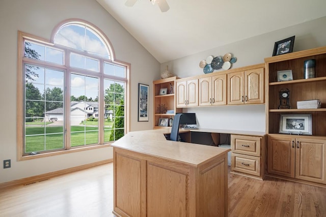 13907 Washington St NE, Ham Lake, MN 55304 - home office with light wood-type flooring, built in desk, ceiling fan, and high vaulted ceiling