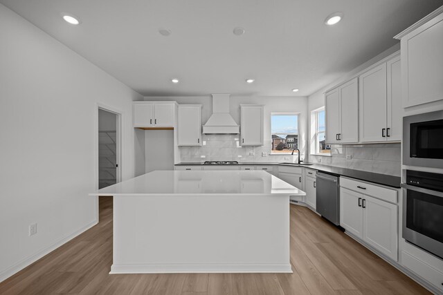 11532 Polaris Ln N, Dayton, MN 55369 - kitchen with custom range hood, stainless steel appliances, a kitchen island, decorative backsplash, and recessed lighting