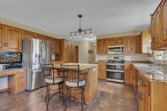2708 Tranquility Dr, Saint Cloud, MN 56301 - kitchen featuring appliances with stainless steel finishes, a center island, light stone counters, dark tile patterned flooring, and brown cabinets