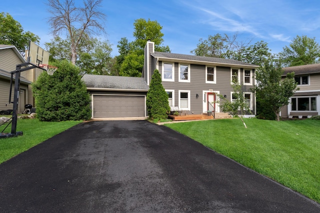 14500 Raleigh Ave, Savage, MN 55378 - colonial home featuring a chimney, an attached garage, driveway, and a front lawn