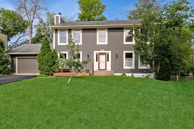 14500 Raleigh Ave, Savage, MN 55378 - colonial home featuring a chimney, driveway, and a front yard