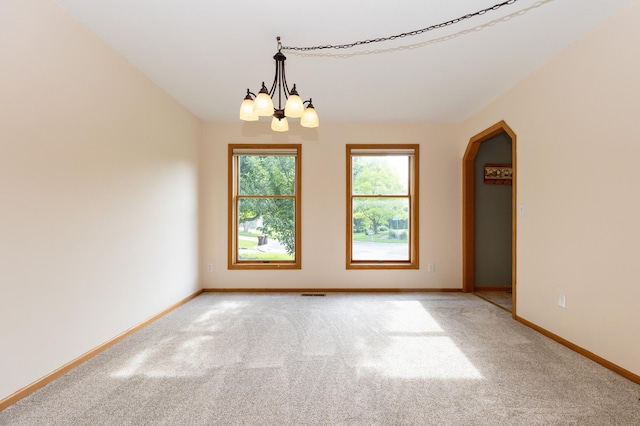 14500 Raleigh Ave, Savage, MN 55378 - empty room featuring a chandelier, light carpet, and arched walkways
