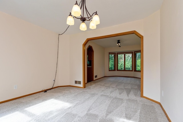 14500 Raleigh Ave, Savage, MN 55378 - spare room with arched walkways, carpet floors, and a chandelier