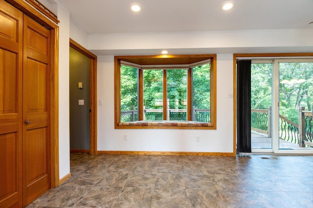 14500 Raleigh Ave, Savage, MN 55378 - unfurnished living room with crown molding, stone finish floors, and recessed lighting