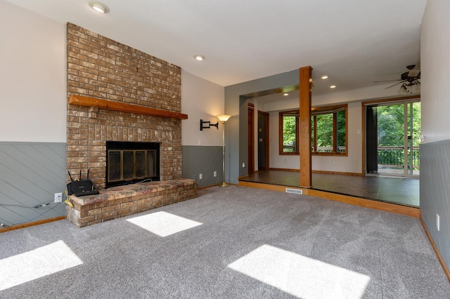 14500 Raleigh Ave, Savage, MN 55378 - unfurnished living room featuring wainscoting, a ceiling fan, carpet flooring, a brick fireplace, and recessed lighting