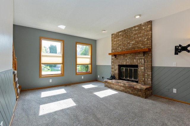 14500 Raleigh Ave, Savage, MN 55378 - unfurnished living room with carpet floors, a fireplace, and wainscoting