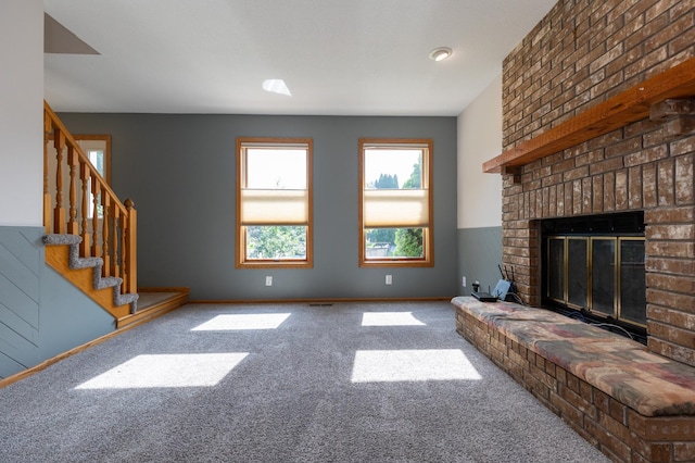 14500 Raleigh Ave, Savage, MN 55378 - unfurnished living room with carpet floors, stairway, and a fireplace