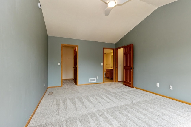 14500 Raleigh Ave, Savage, MN 55378 - unfurnished bedroom with vaulted ceiling, a walk in closet, light colored carpet, ensuite bath, and ceiling fan