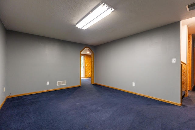 14500 Raleigh Ave, Savage, MN 55378 - empty room with arched walkways, carpet floors, and a textured ceiling